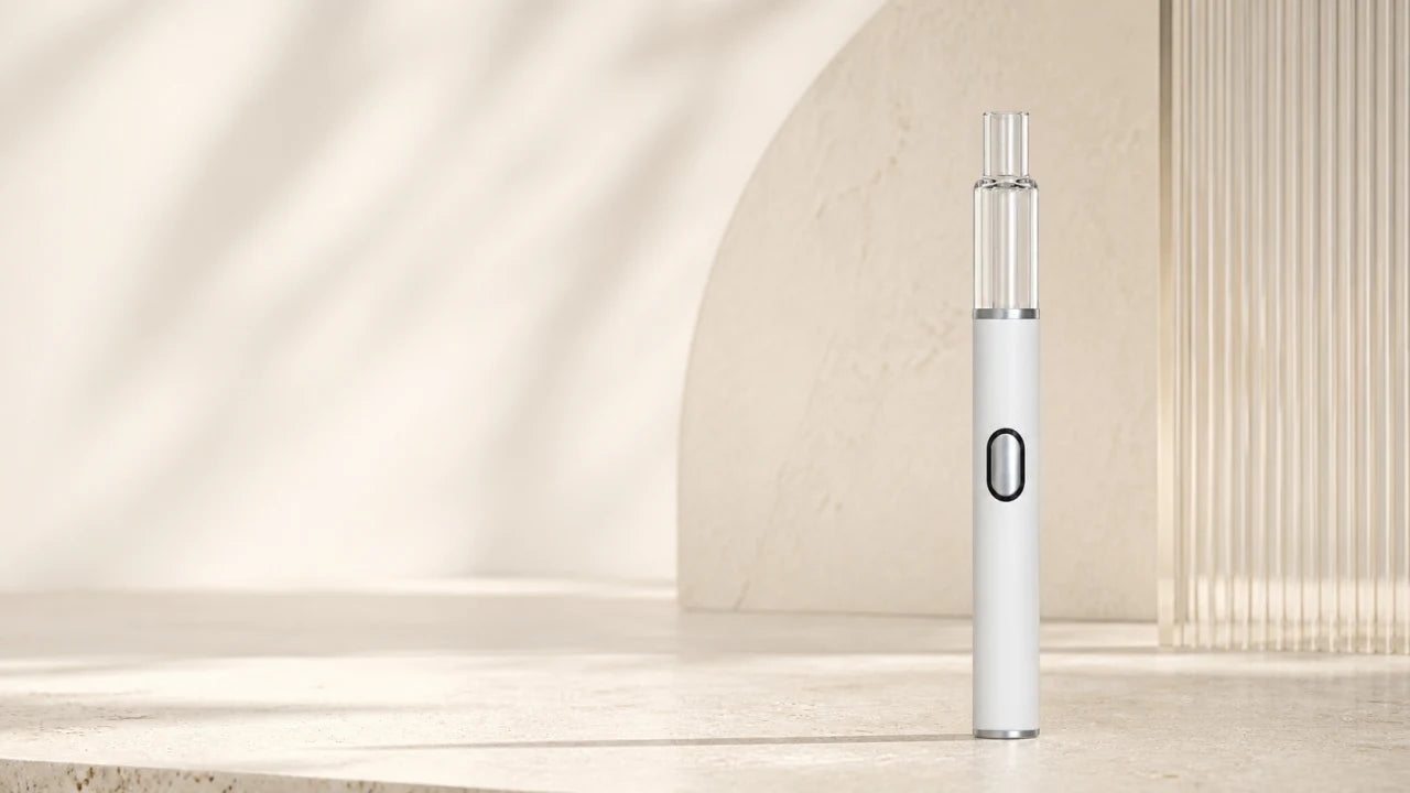 Briar desktop hero regenerated from the new product reference Briar empty 1.0mL glass AIO standing in a warm ivory architectural studio with a metallic button center, black translucent LED ring, and silver bottom cap