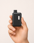Nook compact matte-black 2mL empty disposable vape hardware — handheld scale and product detail thumbnail