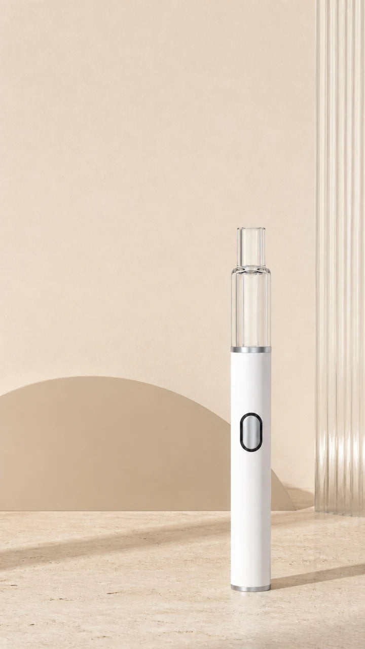 Briar empty 1.0mL glass AIO placed below a clear mobile copy zone in a warm ivory architectural studio, with a metallic button center, dark translucent LED ring, and silver bottom cap