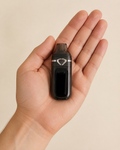 Lumen black dual-chamber empty AIO hardware resting in an adult hand at verified real-world scale thumbnail