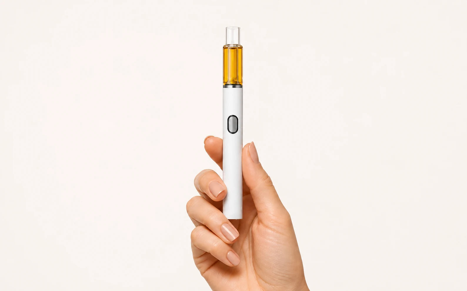 Briar glass all-in-one disposable vape held by a small-batch filling operator