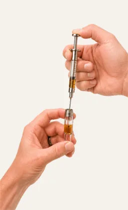 Filling the Briar glass oil tank with a cannabis oil syringe